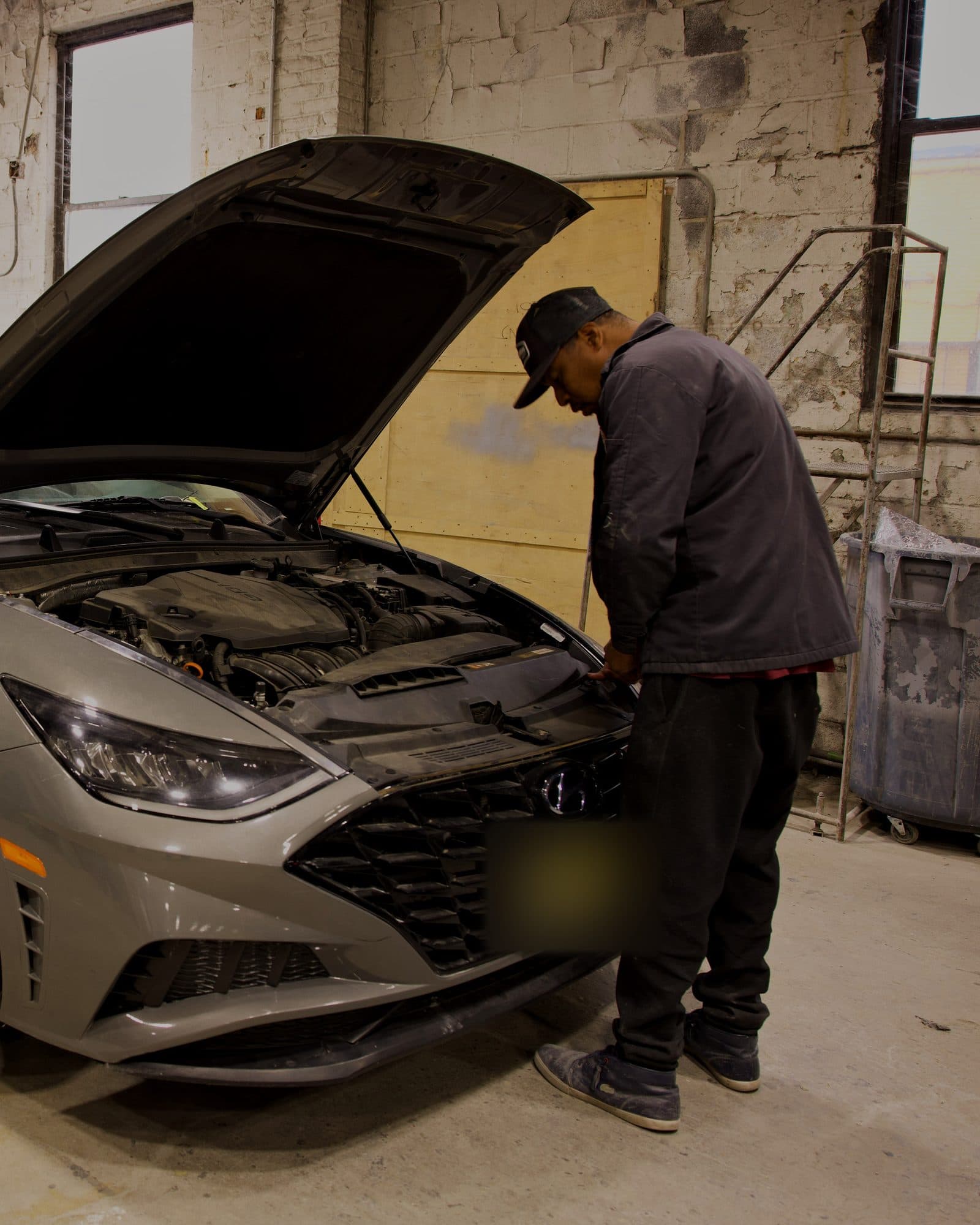 A Car2Fix technician checking the front of a Hyundai Sonata at the Linden shop