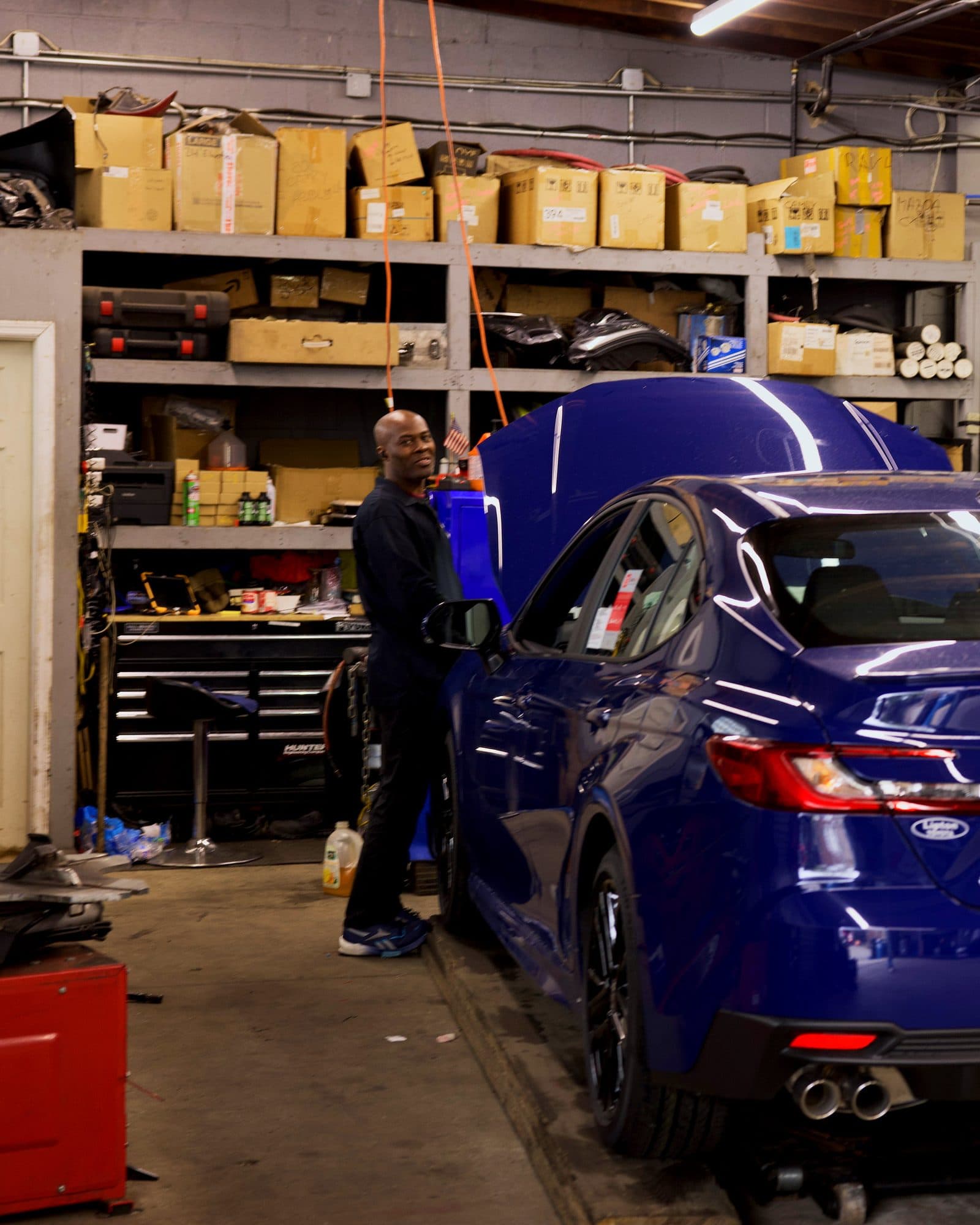 A Car2Fix technician working on a Toyota Camry at the Newark shop